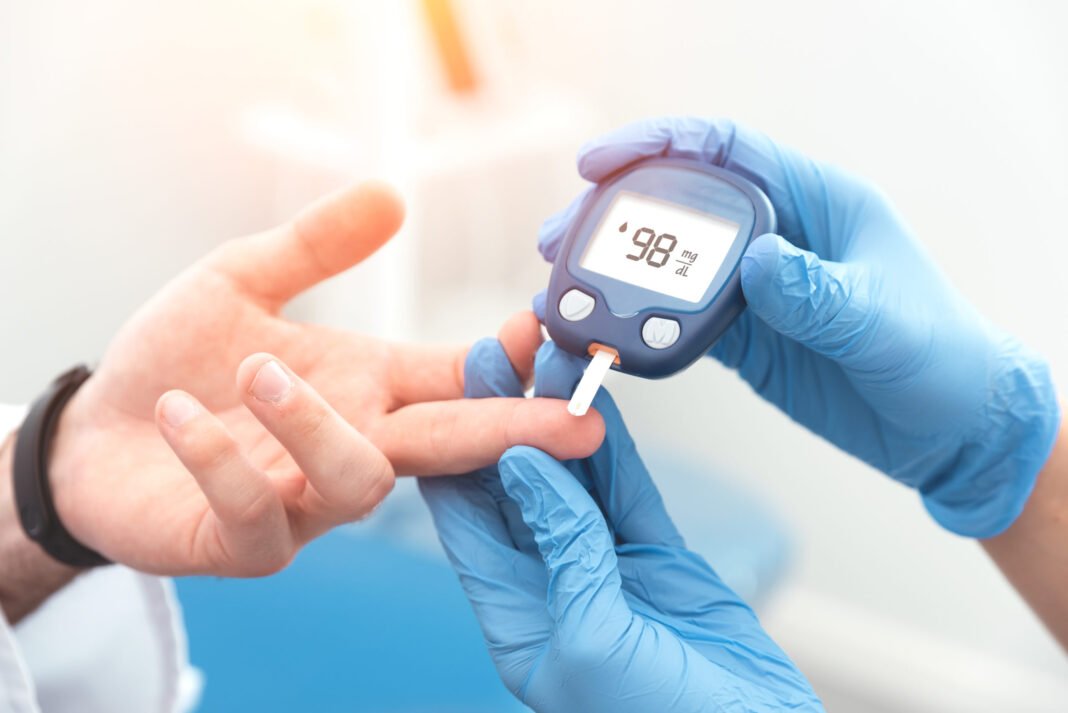 Doctor-checking-blood-sugar-level-with-glucometer-Proxima-Studio--scaled